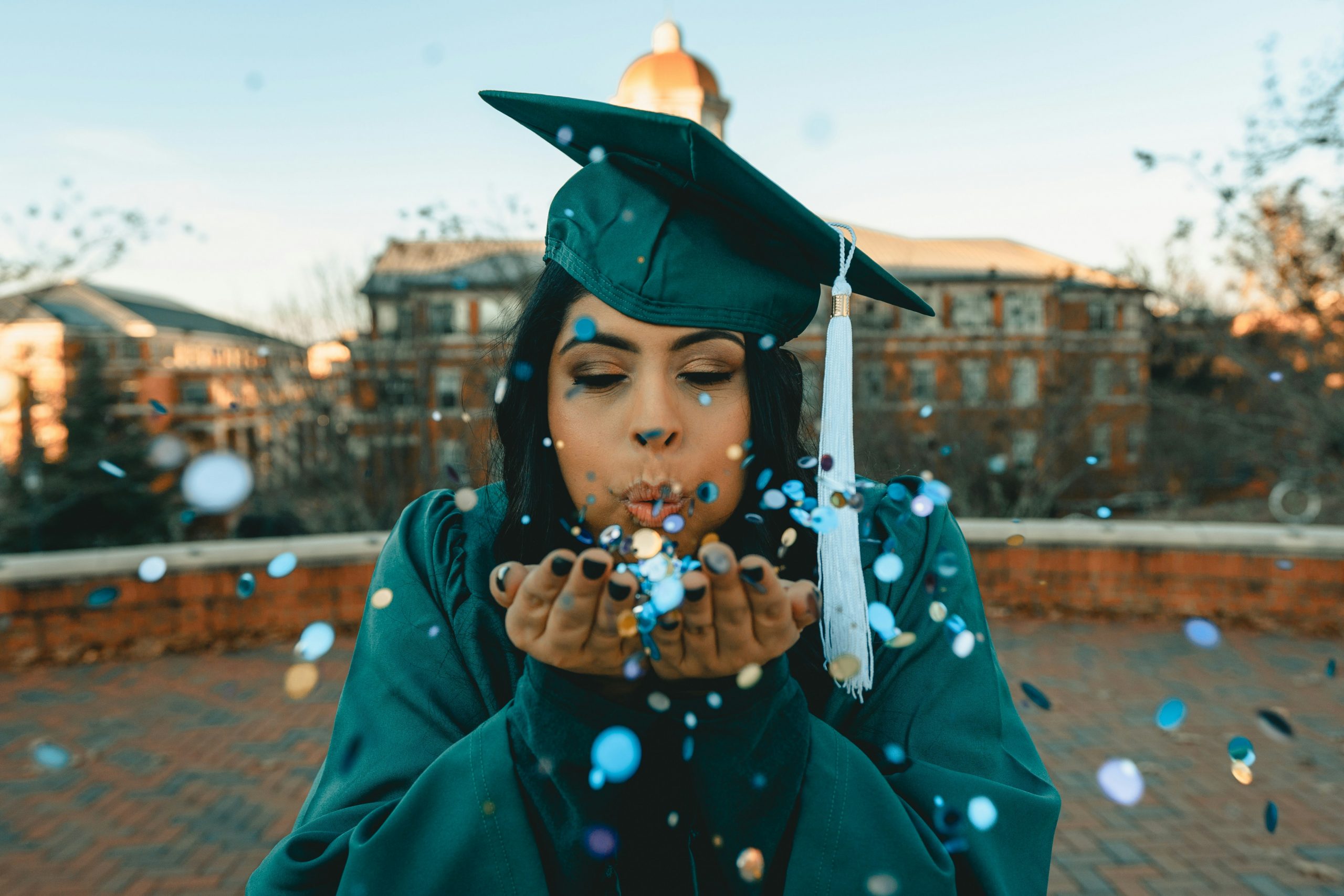 A graduate celebrating graduation at an outdoor venue in mansfield, ohio